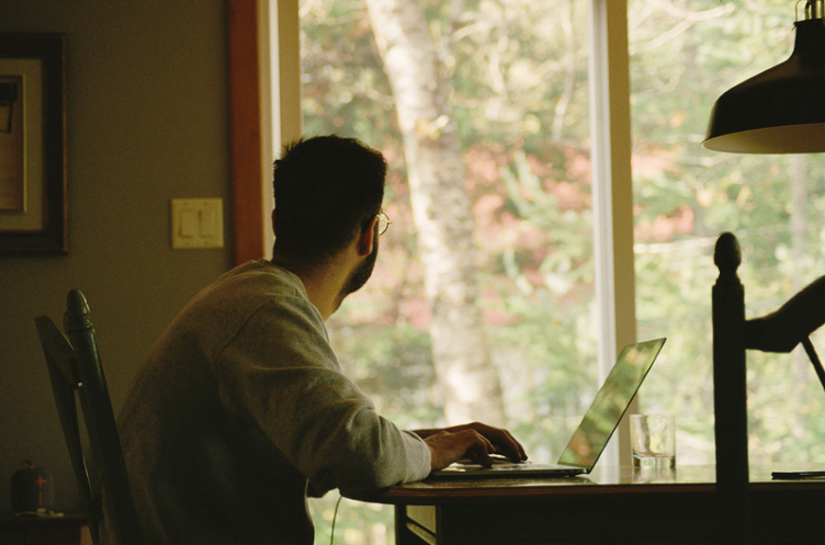 writer writing on laptop